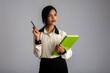 © Dip Photography - Pretty young girl holding book and posing on grey background