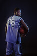 © Nomad_Soul - Basketball player with ball, black background