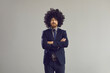 © Studio Romantic - Serious adult caucasian bearded hipster business man in stylish curly hair wig and formal suit standing with arms crossed looking at camera studio portrait shot isolated on grey background.