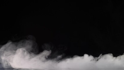 Wall Mural - Smoke flowing on black background