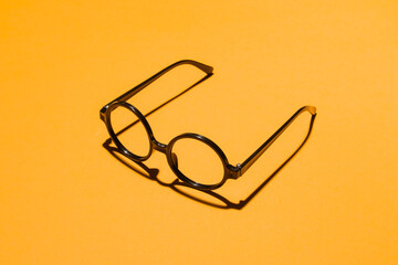 Glasses on orange studio background
