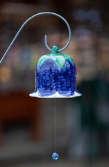 Vertical closeup shot of a hanging blue decorative bell