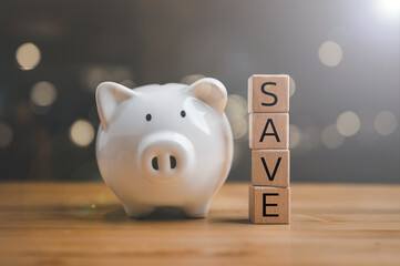 Wall Mural - Save from wood cubes and piggy bank. Money savings, save and investment concept.