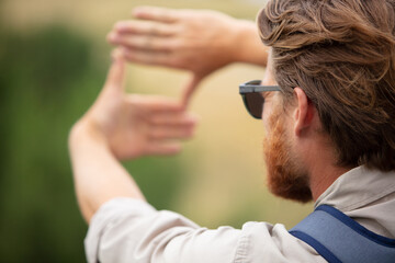 man drawing a square with his hands