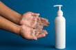 Closeup of person washing hands or using a sanitizing gel. Cleanliness and body care concept.