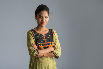 Portrait of beautiful young smiling girl on a grey background.