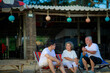 © sutthichai - Happy Asian family enjoy talking together on the sunbed on the beach side restaurant.