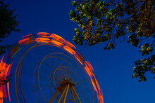 The Moving Ferris Wheel Was Photographed At Night On A Long Shutter Speed