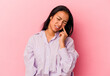 © Asier - Young Venezuelan woman isolated on pink background crying, unhappy with something, agony and confusion concept.