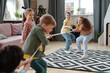 © pressmaster - Two teams of kids pulling rope in home environment
