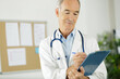 © auremar - a senior doctor with clipboard