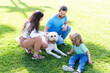 © Olena - friendly family with pet. happy parents with kid boy play with dog.