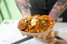 Male Hands With Tattoos Hold Nachos Salsa