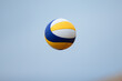 Volleyball game. Beach volleyball ball in the sky.