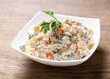 bowl of russian salad olivier with meat and vegetables