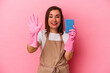 © Asier - Middle age caucasian woman cleaning home isolated on pink background smiling cheerful showing number five with fingers.