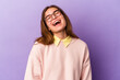 © Asier - Young caucasian woman isolated on purple background relaxed and happy laughing, neck stretched showing teeth.