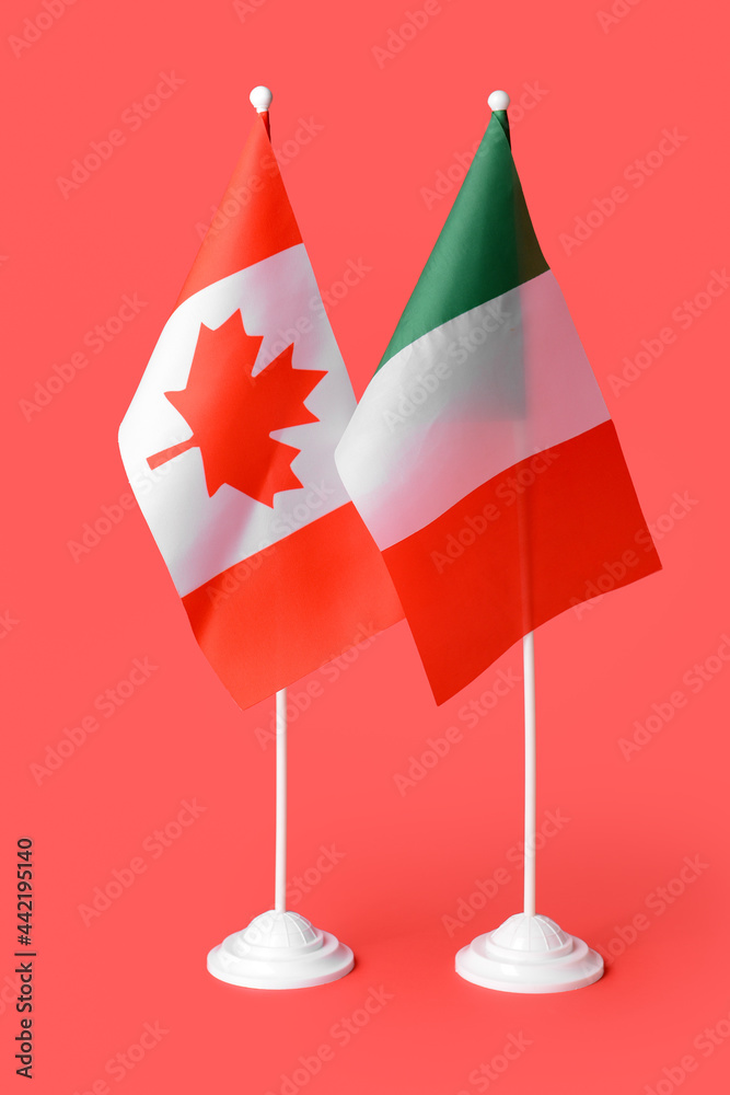 Flags of Italy and Canada on color background