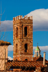 Wall Mural - Winter view of the old Church of Saints John and Reparata rises above Lucca charming historic center roofs and chimneys