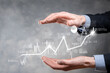 © Ivan - Businessman in hand hold banking business finance graph and invest in stock market investment point,economic growth and investor concept.analysis virtual stock market chart,analyze by use technology