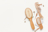 Hair brushes and comb on color background