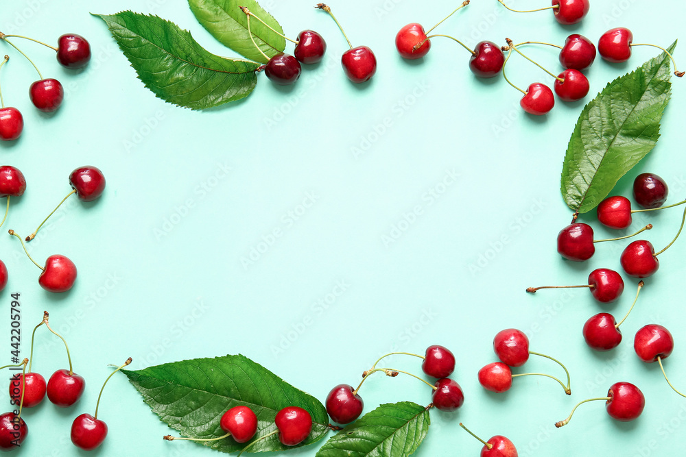 Frame made of tasty ripe cherry on color background