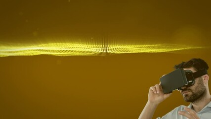 Poster - Caucasian man wearing vr headset against golden digital waves and light spots on yellow background