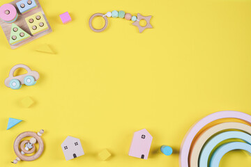 Baby kids toys frame on yellow background. Top view. Flat lay. Copy space for text