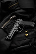 Black modern pistol on a dark back. A short-barreled weapon for concealed carry. Armament of the police, army and special units.
