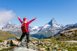 © Angelov - Hiking in the swiss alps with flower field and the Matterhorn peak in the background.