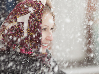 Happy woman walking in the snowy winter day outdoor. Snowing winter beauty fashion concept.