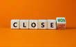 Close won or lost symbol. Turned the wooden cube and changed words Close won to close lost. Beautiful orange background, copy space. Business and close won or lost concept.