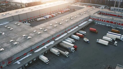 Wall Mural - Semi-trailers trucks stand at warehouse ramps for load and unload goods in a logistics park, loading hub. Aerial view