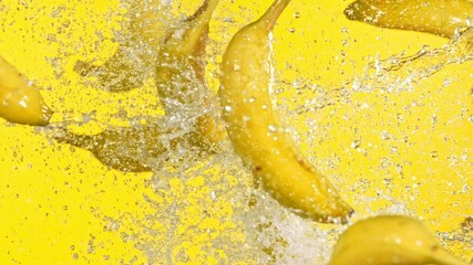 Fototapete - Super slow motion of bananas hitting in the air on yellow background. Filmed on high speed cinema camera, 1000 fps.