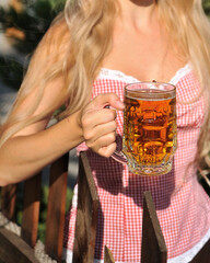 Wall Mural - Beautiful blond woman with glass of beer. Oktoberfest 2021 concept.
