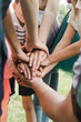 © Vikkin - Many hands lying on top of each other. Friends with stack of hands showing unity and teamwork. Friendship happiness leisure partnership team concept.