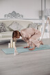 © Вячеслав Косько - Young lady doing gymnastics on floor at home