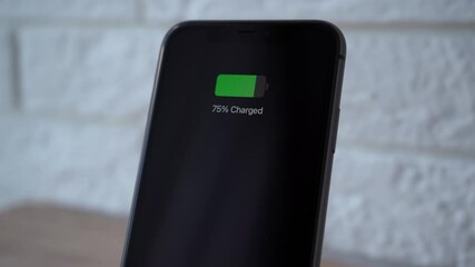 Poster - Process of mobile phone charging on an induction station pad. 4k stock footage.