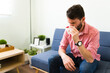 © AntonioDiaz - Latin man with a runny nose at home
