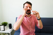 © AntonioDiaz - Latin man with a cold using a nasal spray