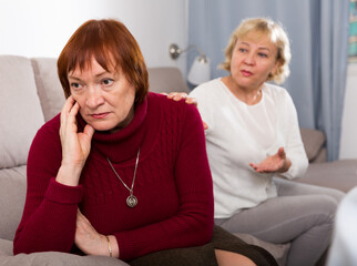 Wall Mural - Two upset mature ladies finding out relationship at home