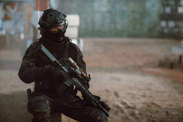 Canvas Print - soldier holding rifle at the battlefield area ready fight. Concept of BB gun combat warrior style.