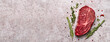 © colnihko - Fresh marbled beef rib eye steak and spices on grey stone banner, copy space