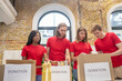 © zinkevych - Student volunteers packing donation boxes together