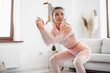 © fotofabrika - Young fitness girl doing sport exercises at her living room at home