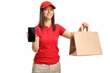 Wall Mural - Young delivery female worker holding a paper takeaway bag and a mobile phone