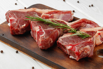 Wall Mural - Raw meat ribs on wooden board on white background