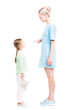 © Mediaphotos - Vertical full length isolated side view shot of young adult woman scolding her daughter for being naughty, white background
