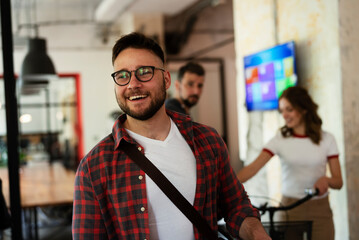 Portrait of handsome businessman in the office. Young man with electric scooter