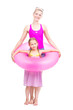 © Mediaphotos - Vertical full length studio portrait of modern Caucasian woman and girl wearing summer clothes standing together in swim ring having fun